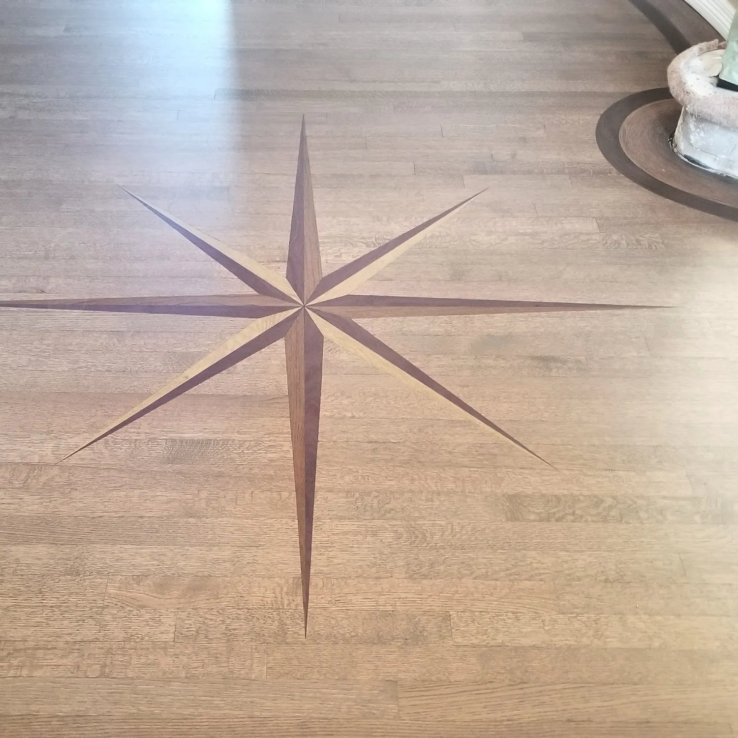 Eight-point compass rose medallion inlaid into a hardwood floor