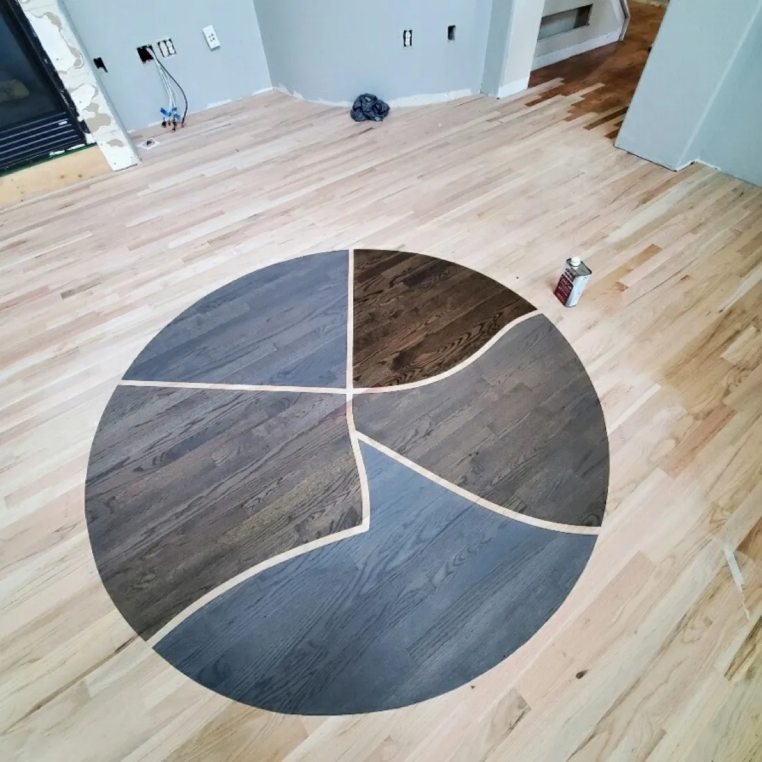 Circular four-part medallion set into a pale oak floor